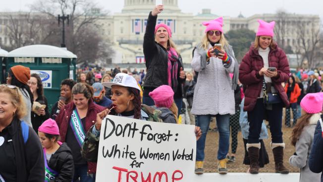 Angela Peoples holds a sign highlighting the issue of intersectionality within the feminist movement. Credit: Kevin Banette/@afroCHuBBZ and @MsPeoples